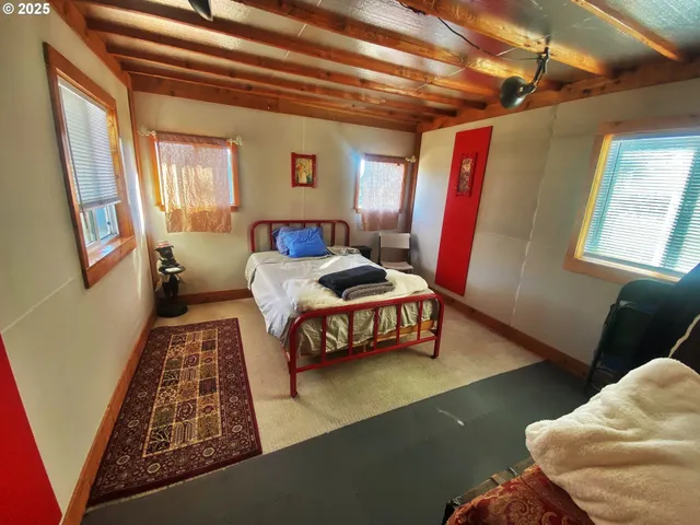 a bedroom with furniture and a window