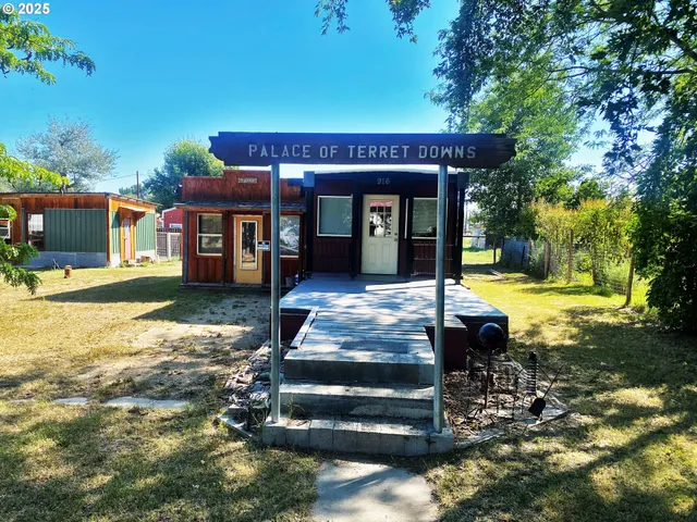 a view of a house with backyard porch and sitting area