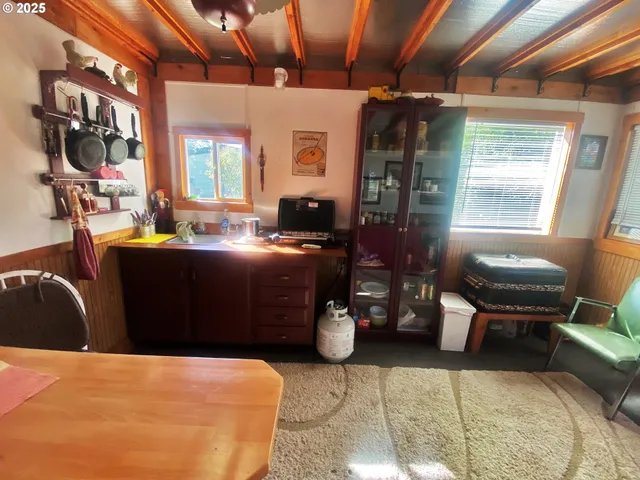 a room with furniture a flat screen tv and windows