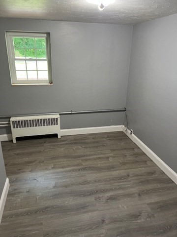 404 Cedar Street Hanover, MA 02339 - Photo 14 of 17 a view of a room with wooden floor and white walls