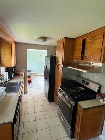 404 Cedar Street Hanover, MA 02339 - Photo 5 of 17 a kitchen with a refrigerator a stove a sink and a dining table