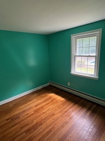 404 Cedar Street Hanover, MA 02339 - Photo 8 of 17 a view of an empty room with wooden floor and a window