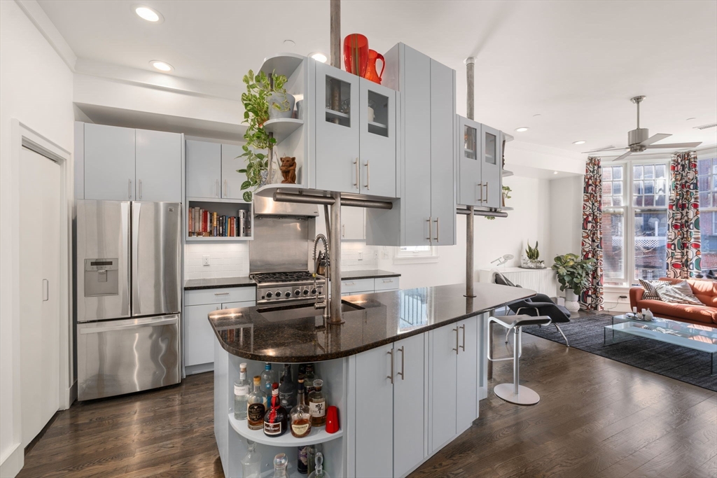 a kitchen with a sink appliances and cabinets