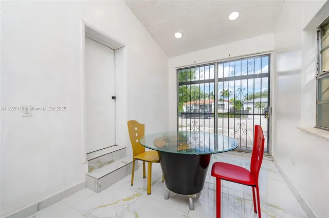 a view of a dining room with furniture window and outside view