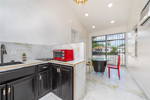 a utility room with a sink cabinets and appliances