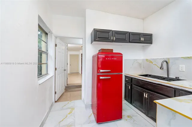 a kitchen with stainless steel appliances granite countertop a refrigerator and a stove