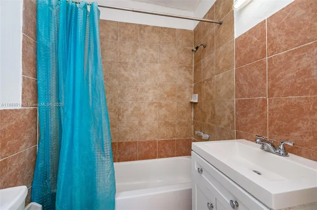 a bathroom with a sink a mirror and a bathtub