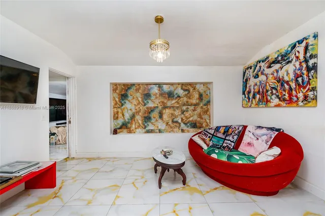 a view of a dining room with furniture and a chandelier