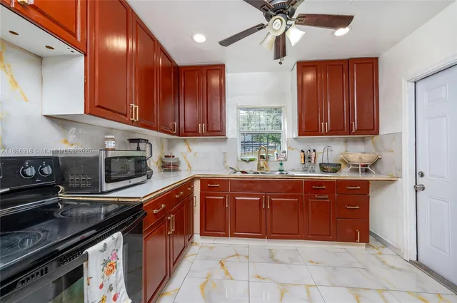 a kitchen with stainless steel appliances granite countertop a sink stove and cabinets