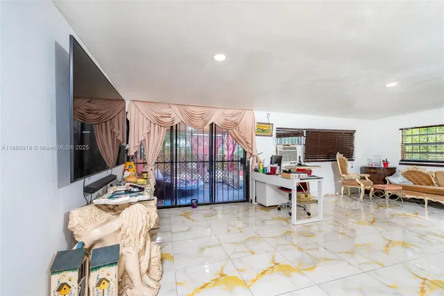 a living room with furniture and kitchen view