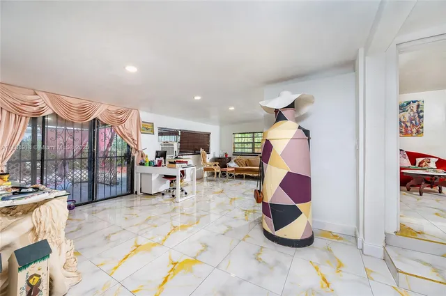 a view of a house with backyard and sitting area