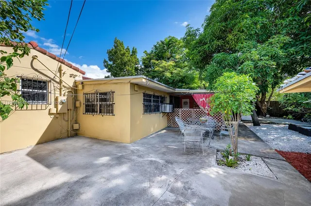a view of a backyard with large trees