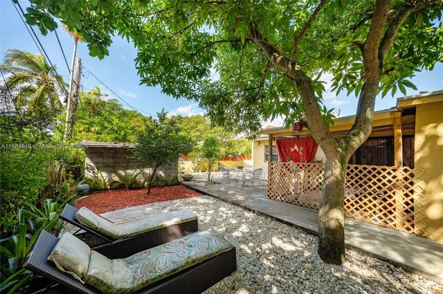 a view of a patio with table and chairs and potted plants