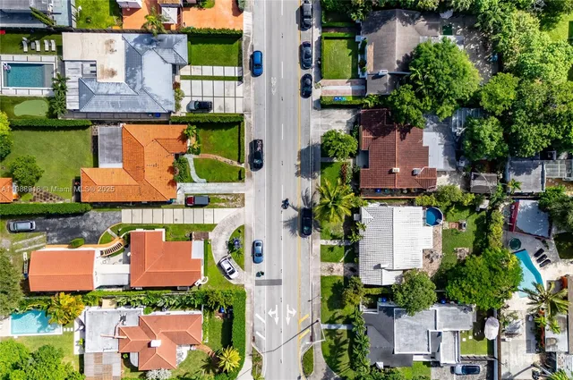 an aerial view of a house with a garden and a lake view