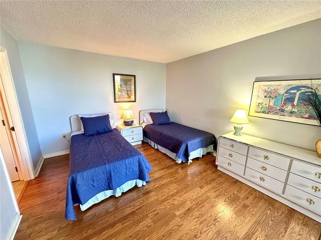 a bedroom with furniture and wooden floor