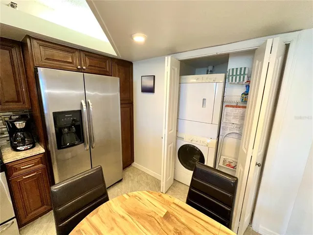 a bedroom with a bed and a refrigerator