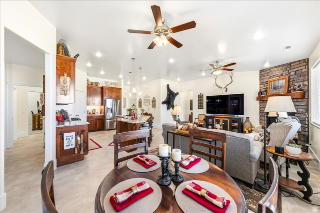 357 East Main Street Enterprise, UT 84725 - Photo 12 of 71 Dining area featuring ceiling fan, light flooring, a stone fireplace, and recessed lighting