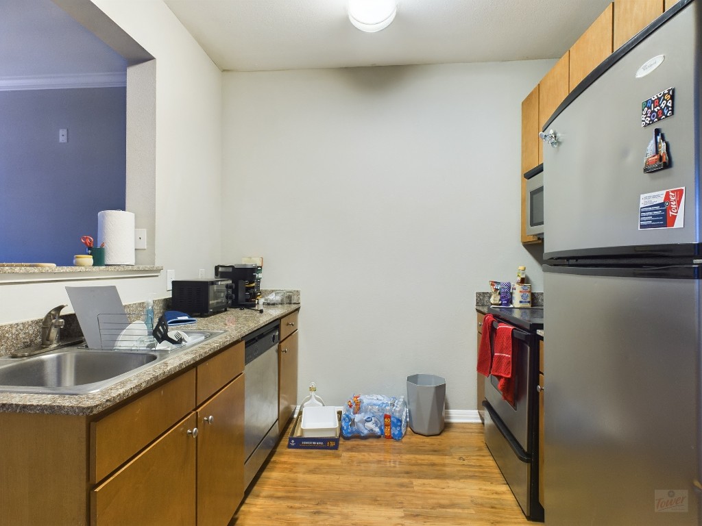 2502 Leon Street, Unit 218 Austin, TX 78705 - Photo 2 of 15 a kitchen with a sink and cabinets