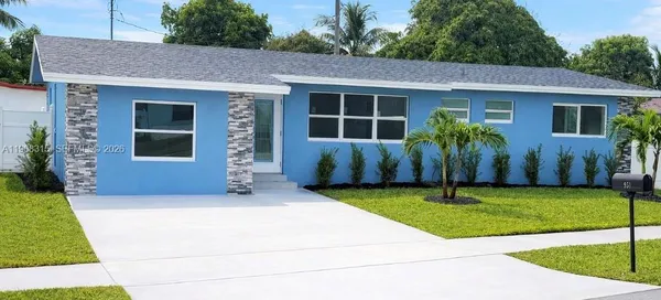 a front view of house with yard and outdoor seating