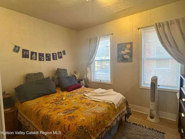 a bed sitting in a bedroom next to a window