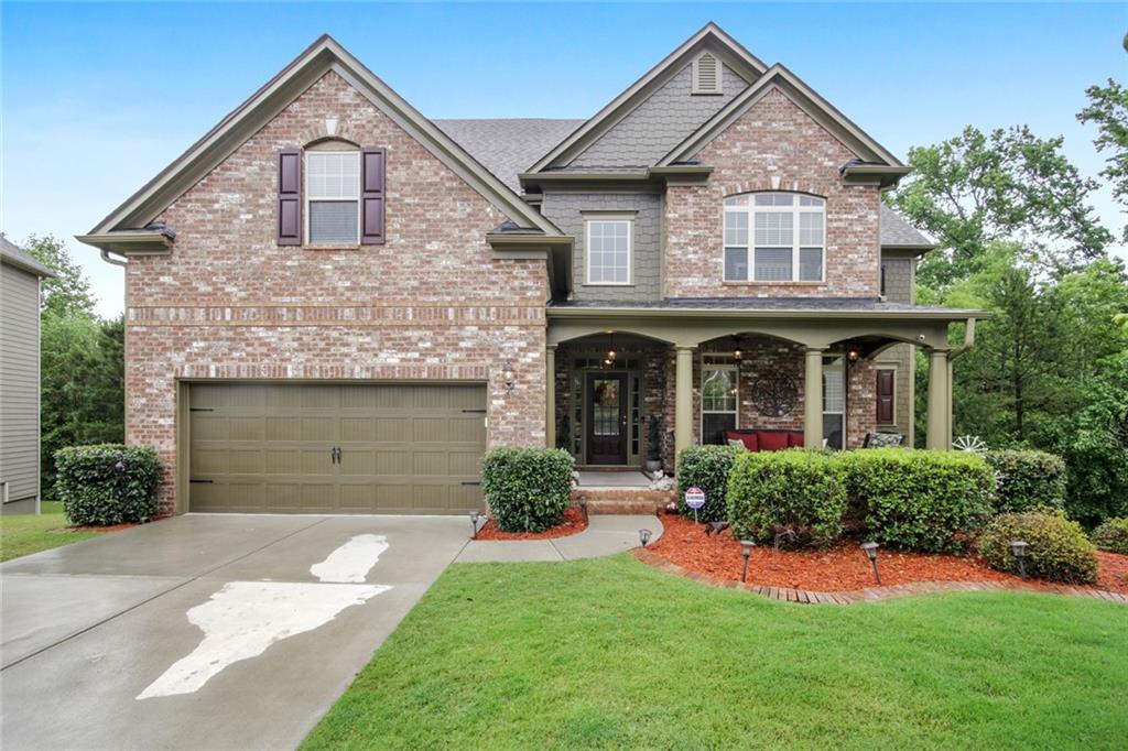 Welcoming home in the Highlands at Sawnee Mountain located on a wooded, cul-de-sac lot.
