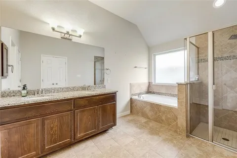 a spacious bathroom with a granite countertop sink a toilet a mirror and glass door