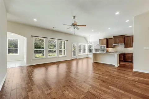 a view of kitchen with granite countertop window and wooden floor
