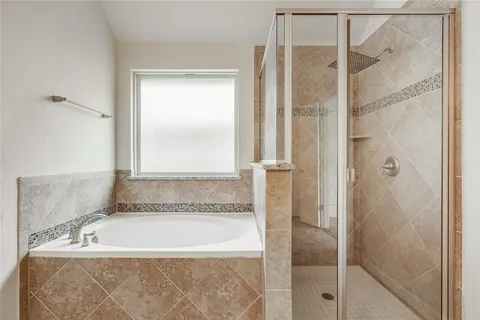 a bathroom with a bathtub and shower