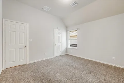 a view of an empty room and a window