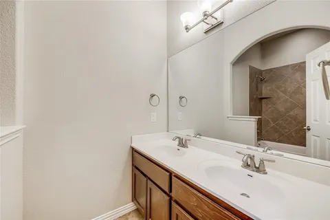 a bathroom with a sink vanity and a mirror
