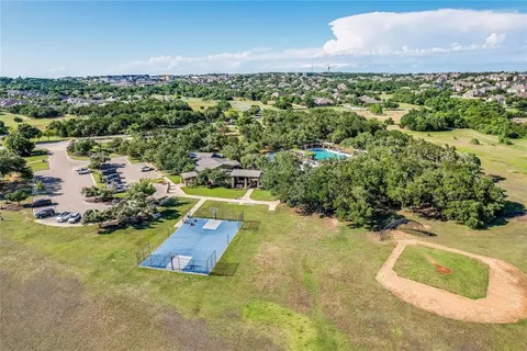 an aerial view of a house with a yard and lake view