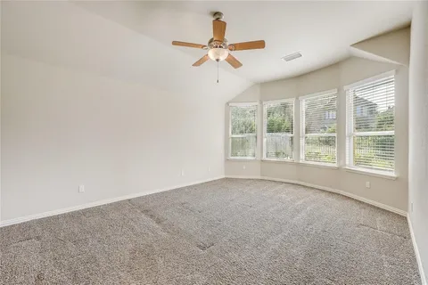 a view of a livingroom with a ceiling fan and window