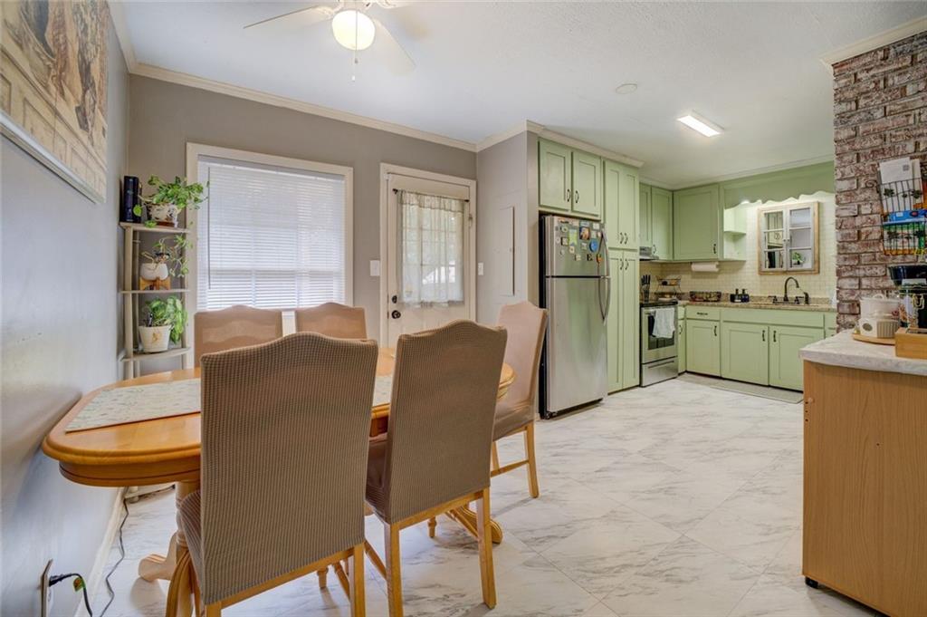 11889 Brown Bridge Road Covington, GA 30016 - Photo 12 of 27 a living room with stainless steel appliances furniture a rug and a kitchen view