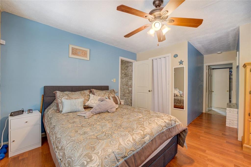 11889 Brown Bridge Road Covington, GA 30016 - Photo 13 of 27 a bedroom with a bed and a chandelier