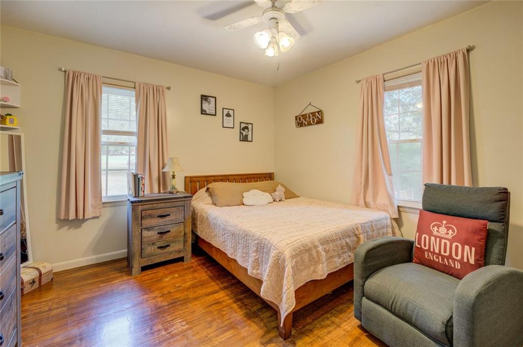 11889 Brown Bridge Road Covington, GA 30016 - Photo 14 of 27 a bedroom with a bed and a couch next to a window