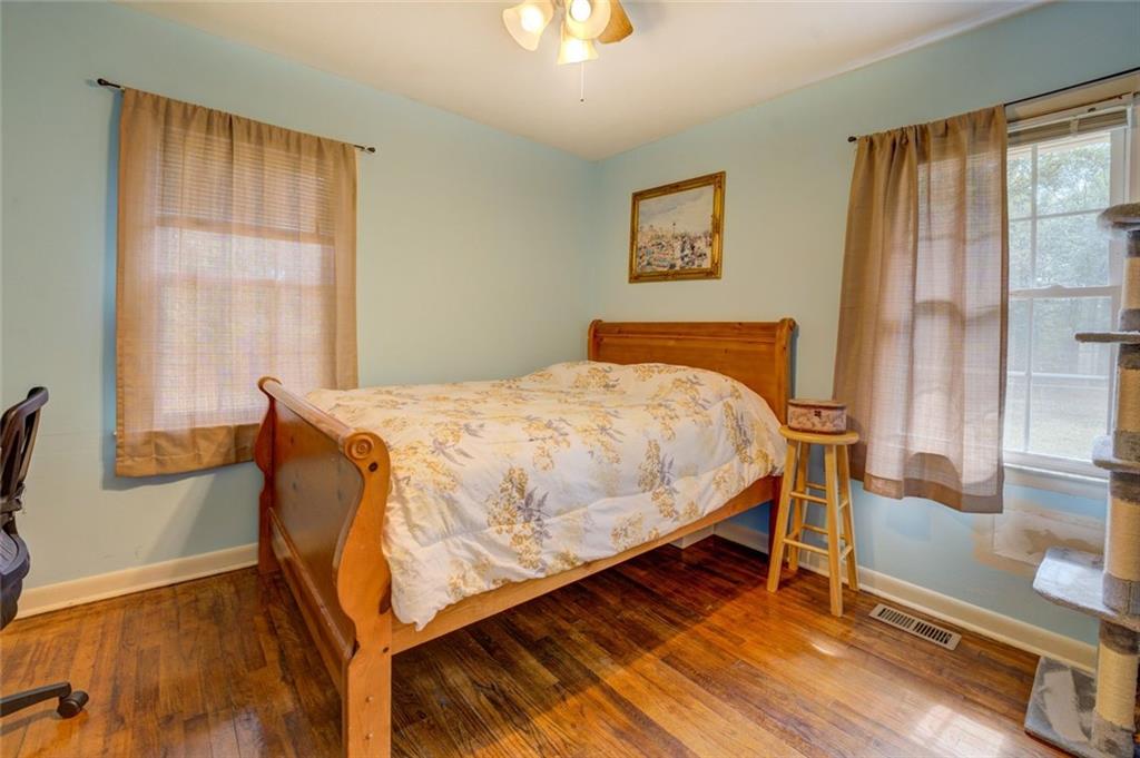 11889 Brown Bridge Road Covington, GA 30016 - Photo 15 of 27 a bedroom with a bed and wooden floor