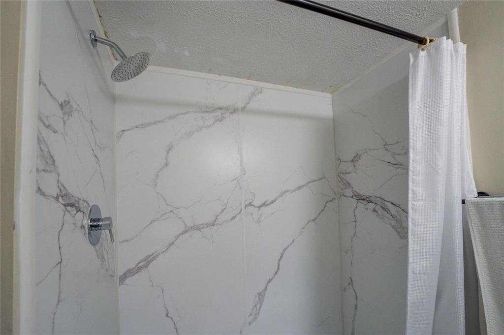 11889 Brown Bridge Road Covington, GA 30016 - Photo 16 of 27 a bathroom with a shower