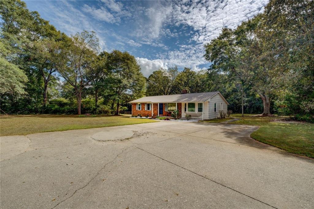 11889 Brown Bridge Road Covington, GA 30016 - Photo 21 of 27 a front view of a house with a yard