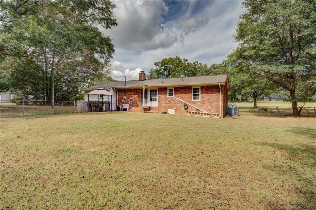 11889 Brown Bridge Road Covington, GA 30016 - Photo 23 of 27 a front view of a house with a yard