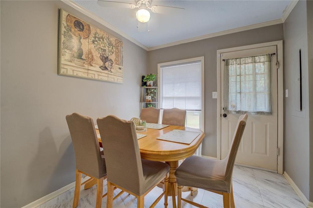 11889 Brown Bridge Road Covington, GA 30016 - Photo 8 of 27 a view of a dining room with furniture and wooden floor