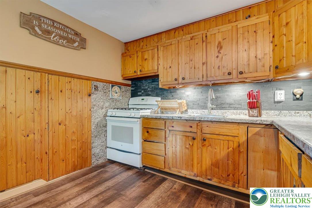 173 Anchorage Road Saylorsburg, PA 18353 - Photo 15 of 75 a kitchen with stainless steel appliances granite countertop a sink cabinets and wooden floor