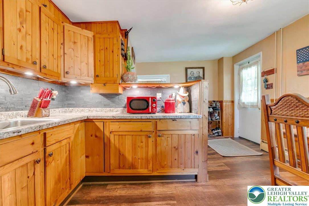 173 Anchorage Road Saylorsburg, PA 18353 - Photo 16 of 75 a kitchen with stainless steel appliances granite countertop a sink and cabinets