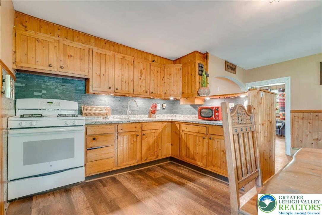173 Anchorage Road Saylorsburg, PA 18353 - Photo 17 of 75 a kitchen with stainless steel appliances granite countertop a refrigerator sink and white cabinets