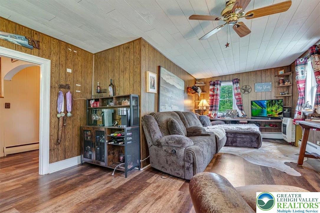 173 Anchorage Road Saylorsburg, PA 18353 - Photo 21 of 75 a living room with furniture and a fireplace