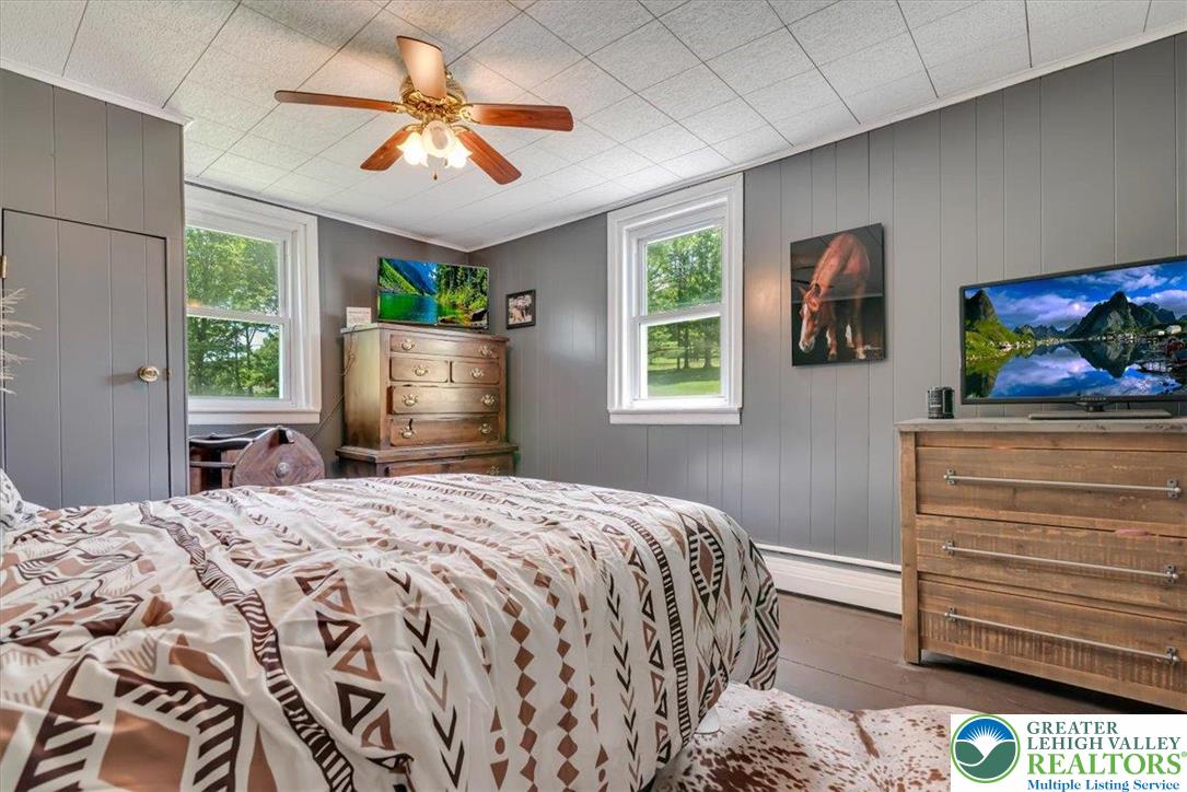 173 Anchorage Road Saylorsburg, PA 18353 - Photo 37 of 75 a bedroom with a bed and a chandelier