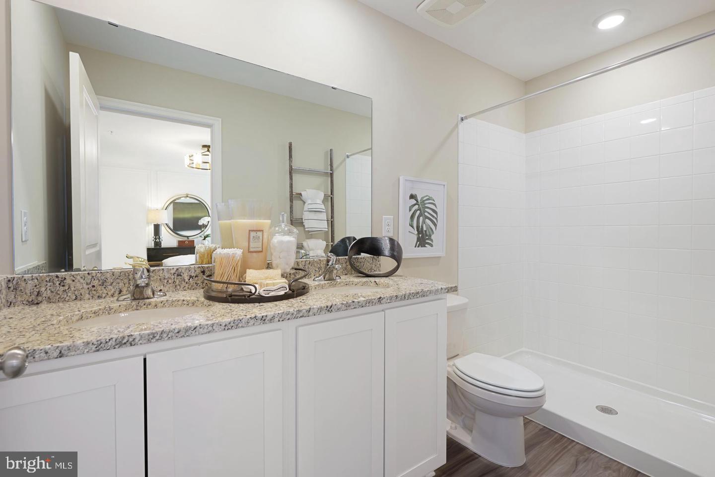 1995 Fauna Drive Frederick, MD 21702 - Photo 14 of 20 a bathroom with a granite countertop sink a toilet and a mirror