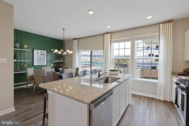a kitchen with granite countertop a sink and wooden floor
