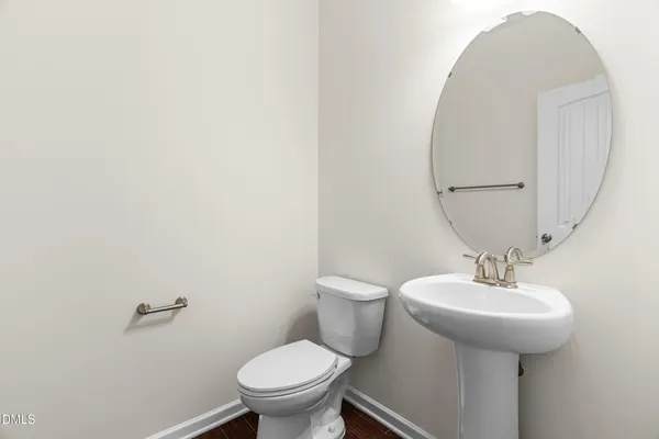 a bathroom with a sink toilet and a mirror