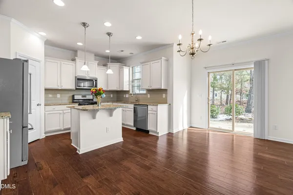 a kitchen with a refrigerator a sink and cabinets