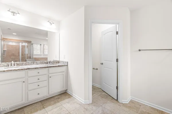 a bathroom with a granite countertop sink two mirror and a